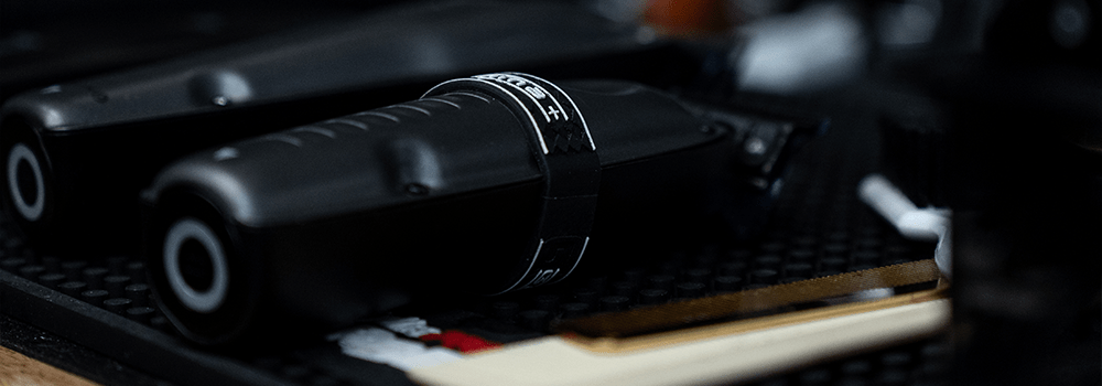 Close-up of black professional hair clippers and attachments on a barber’s tray, showcasing the premium grooming tools used at Montana Fades in Oakville, Ontario.